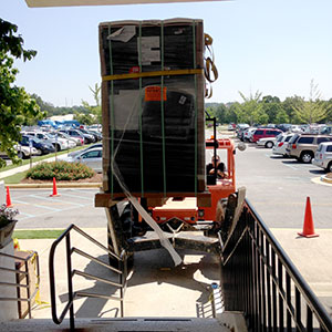 Delivering a safe using a loader